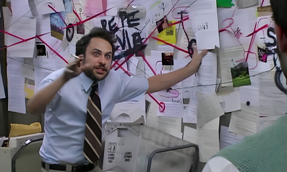 The meme of Charlie Day pointing at a bulletin board with an unsettling face expression